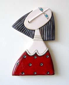 a red and white wall hanging with a woman's face