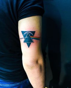 a man's arm with a tattoo on it and a triangle in the middle