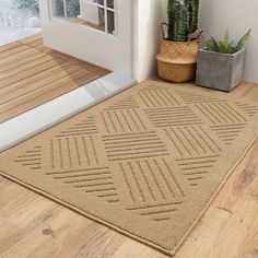 a door mat is on the floor next to a potted plant and window sill