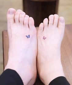 two small butterflies on the feet of a woman