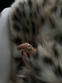 a close up of a person's hand on a chair with a leopard print