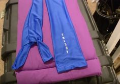 two blue and pink yoga mats sitting on top of each other