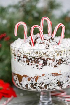 peppermint brownie trifle with white frosting and candy canes on top