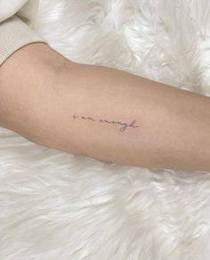 a woman's arm with a tattoo that reads, mommy