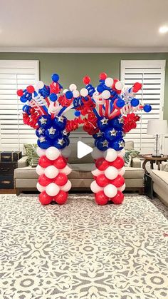 an american flag balloon arch with red, white and blue balloons