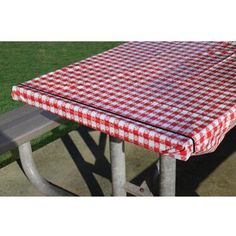 a red and white checkered picnic table cover