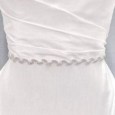 Bridal Leaf Belt, Bridal Belt Leaf, Leaf Bridal Belt, Wedding Leaf Sash, Belts for Wedding Dress Enhance your wedding gown with the delicate radiance of our Bridal Leaf Belt. Experience the subtle beauty of this slender accessory. Sparkle and glow on your special day. 💖 Details - Embellishment measures 17.75 inches long and .75 inches wide - Measures 98.5 inches long - Handmade with sparkling rhinestones 💖 Packaging Each accessory is delicately packaged in our exclusive soft and luxe velvet bag, ensuring its pristine condition until your special day. 💖 Shipping This item is currently in stock, and will be shipped within 2 business days from NY 💖 Returns & Exchanges At bridal accessories shop, we understand that planning your dream wedding can be a whirlwind, and your desire to look lik Silver Bridesmaid Sashes Bridal Accessories, White Wedding Dress With Sashes, Silver Fitted Bridal Accessories, Fitted Bridal Sashes For Bride, White Fitted Bride Sash, Elegant Bridal Sashes, Elegant Bridal Sashes For Bride, Silver Fitted Bridal Belt, Fitted Silver Bridal Belt For Bride