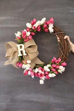 a wreath with pink and white tulips on it