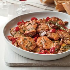 a white bowl filled with meat and vegetables