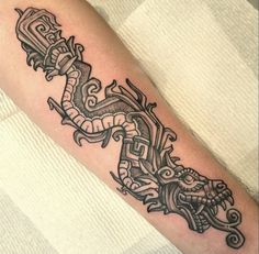 a black and white tattoo on the arm of a man with an ornate dragon design