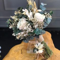 a bouquet of flowers sitting on top of a wooden table