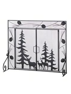 a wrought iron fireplace screen with deer and pine trees