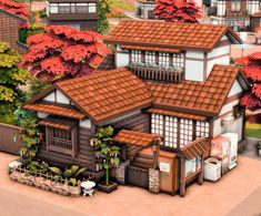 an image of a japanese style house in the middle of some trees and houses with red leaves on them