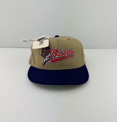 a baseball cap with the word braves on it and a tag hanging from it's side