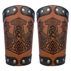 two brown and black leather gaiters with designs on them