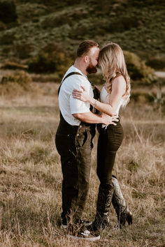 a man and woman standing together in a field