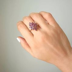 This vintage piece features a beautiful Marquise shaped Amethyst cluster set in 14K Yellow Gold. The Amethyst stones make up approximately 1 carat total weight and the ring weighs 4 grams. An eye-catching and timeless addition to any jewelry collection. Size 7 sizing available with fee contact us to have it added to the price before checkout.Thank you for visiting our shop!Visit our website DmKJewelry.comAlso Follow us on Instagram https://www.instagram.com/dmkjewelryny/ 14k Gold Birthstone Cluster Ring, Heirloom Cluster Ring Gift, 14k Gold Cluster Ring With Birthstone, Purple Cluster Ring With Accent Stones, Cluster Ring With Accent Stones For Gift, Pink Cluster Ring With Gemstone, Pink Cluster Gemstone Ring, Purple Multi-stone Cluster Ring For Anniversary, Elegant Purple Multi-stone Cluster Ring