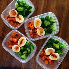 four plastic containers filled with different types of vegetables and hard boiled eggs on top of broccoli