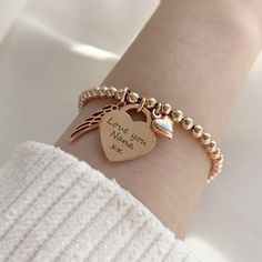 It's the RETURN memorial bracelet - designed to commemorate cherished memories. This beautiful rose gold vermeil bracelet combines a rose gold heart charm which can be engraved with a loved one's name, alongside a pretty rose gold angel wing and a dainty rose gold heart charm. The rose gold vermeil heart charm measures 16mm across the front of the heart, perfect for engraving a name or message, and sits centrally on a rose gold vermeil ball bracelet crafted with 4mm beads. The pretty rose gold v Valentine's Day Rose Gold Heart Charm, Rose Gold Charm Bracelets As Gift, Rose Gold Charms For Valentine's Day, Rose Gold Bracelets With Charms As Gift, Rose Gold Bracelets With Charms For Gift, Rose Gold Charm Bracelet With Heart Charm As Gift, Rose Gold Charm Bracelet With Heart As Gift, Rose Gold Heart Charm Bracelets For Anniversary, Rose Gold Bracelet With Heart Charm For Anniversary