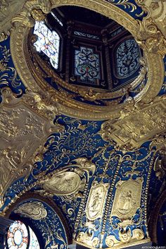 an ornately decorated ceiling with stained glass windows