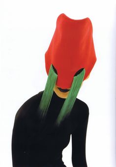 a woman with long green hair and a red hat on her head is looking down at the ground