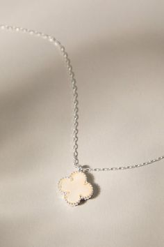 This delicate silver necklace features a double-sided clover charm, showcasing the iridescent beauty of mother-of-pearl on both sides. A timeless symbol of luck and love, this necklace is a beautiful and meaningful addition to any jewelry collection. Delicate Silver Necklace, Symbol Of Luck, Timeless Symbol, Clover Charm, Clover Necklace, Accessories Jewelry Necklace, Heels & Wedges, Altar'd State, Mother Of Pearl