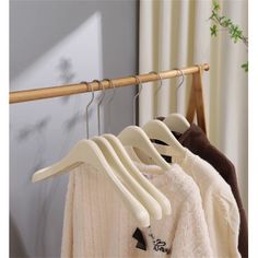 three hangers are hanging on the clothes rack