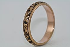 Welcome to Master Piece Jewelers, Specializing in Custom Designs, Engagement Rings, Wedding Bands, Bridal Sets, Diamonds, Colored Stones, and Estate Jewelry. This is a beautiful 14kt black and pink gold with deep hand engraving and floral motif. The ring measures 4.2mm wide and 1.6mm high. Simple and stunning. Ring Specifications - Metal: 14kt Pink Gold (can also be ordered in 10kt, 14kt, or 18kt white, yellow, or rose gold and platinum) - Finger Size: 6.5 or we can size it to fit your finger si Elegant Yellow Gold Ceremonial Bands, Luxury Carved Jewelry For Weddings, Wedding Band With Engraving Option, Round Engraved Bands For Marriage, Victorian Engraved Ring For Formal Occasions, Elegant Etched Rings For Formal Occasions, Formal Elegant Etched Rings, Luxury 14k Stamped Wedding Band, Classic Engraved Ring For Marriage