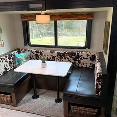 a living area with couches, table and window in the back wall is shown