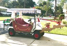 an old man driving a golf cart with santa clause decorations on the roof and side