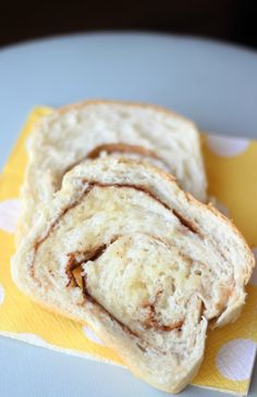 two pieces of bread sitting on top of a yellow napkin