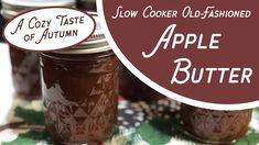 two jars filled with apple butter sitting on top of a table