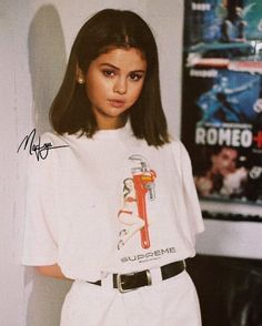 a black and white photo of a woman wearing a t - shirt that says supreme