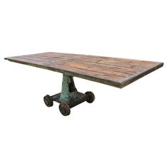 an old wooden table with wheels on it