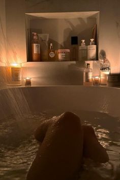 a bathtub filled with lots of soap and candles