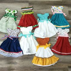 several different types of dresses on a wooden floor