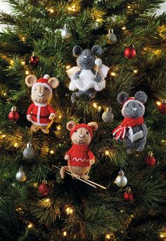 three teddy bears are hanging on the christmas tree