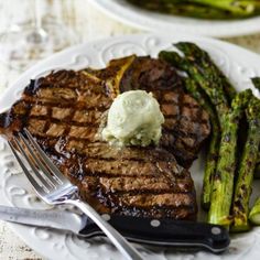 steak, asparagus and mashed potatoes on a white plate with silverware