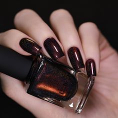 Dash of Cocoa is a delectable dark chocolate holographic nail polish with a standout red-to-gold center. Lounge near the fireplace with Dash of Cocoa, an irresistible holographic with an intense red center that ignites like a warm, lively flame! Subtly shifting from red to gold, the intensely deep chocolate base of Dash of Cocoa pairs perfectly with color-shifting shimmer to create an impressionably sharp and luscious finish loaded with contrast! Dash of Cocoa is part of the 'Tis The Season Coll Holo Nail Polish, Shimmer Nail Polish, Holo Nails, Trending Nails, Dark Nails