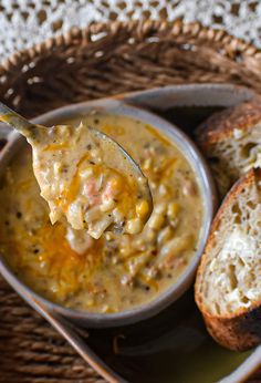 a spoon full of soup and bread on a plate