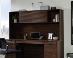 an office desk with a computer on it and a chair in front of the desk