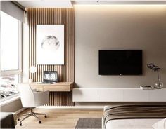 a bedroom with a bed, desk and television on the wall in front of it