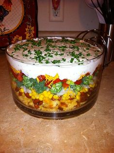 a glass dish filled with food on top of a counter