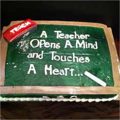 a green cake with writing on it that says a teacher opens a mind and touches a heart