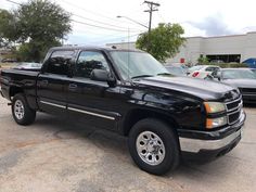 a black pickup truck parked in a parking lot