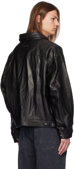 Grained lambskin leather jacket. · Spread collar · Button closure · Flap and welt pockets · Cropped hem · Dropped shoulders · Single-button barrel cuffs · Adjustable button tabs at back hem · Welt pockets at interior · Logo-woven nylon satin lining · Logo-engraved gunmetal hardware Supplier color: Black Classic Leather Jacket With Padded Collar For Work, Classic Leather Biker Jacket With Button Closure, Classic Single Breasted Biker Jacket, Classic Biker Jacket With Padded Collar, Leather Jacket With Button Cuffs And Long Sleeves, Classic Leather Outerwear With Button Cuffs, Classic Leather Jacket With Button Cuffs, Business Leather Jacket With Button Cuffs And Long Sleeves, Business Leather Jacket With Button Cuffs