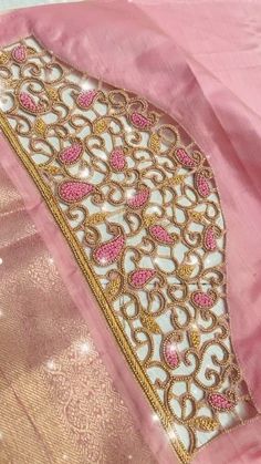 a pink and gold saree with intricate designs on the border, along with sequins