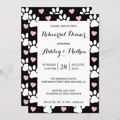 a wedding card with pink hearts and paw prints on the front, and black background