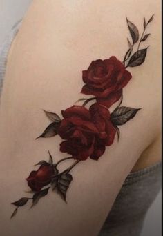 a woman's shoulder with red roses on it