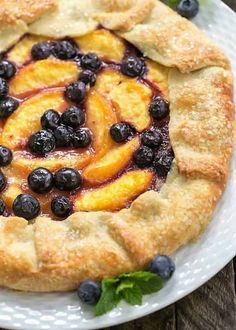 a pie with blueberries and peaches on it